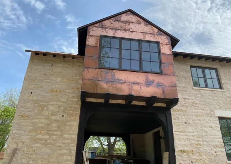 Copper metal panel facade on a stone building for Metal Roof Coating in Polson
