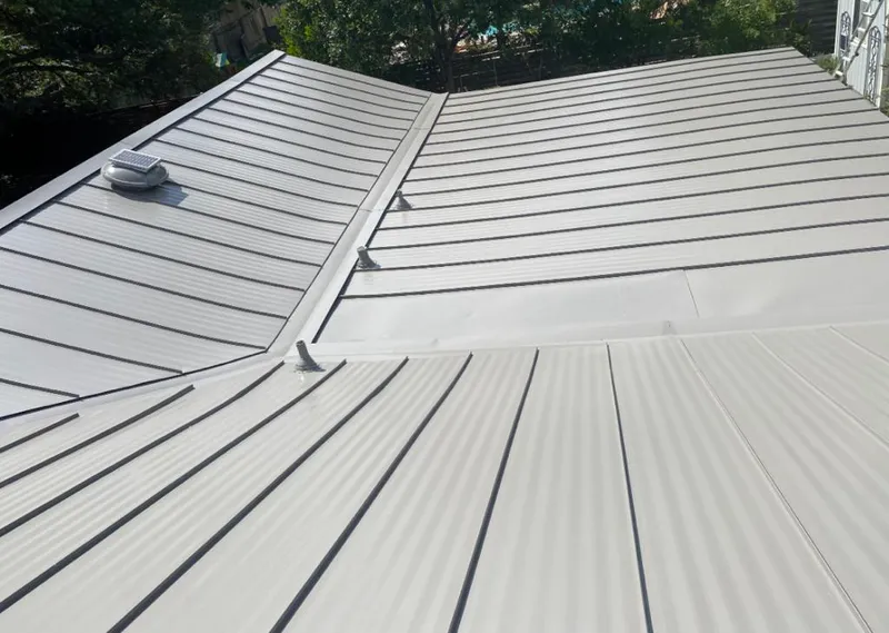 Solar attic fan installed on a metal roof for Roof Ventilation in Polson